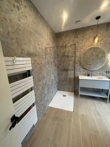 a bathroom with a shower and a sink and a mirror at VILLA BEL AIR CANNES - 240m2 - Freshly completely renovated - Beach - Pool - No Party allowed - No bachelor-ette stay in Cannes