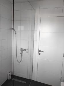 a shower with a glass door in a bathroom at Apartman MiMa in Pale