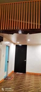 a room with a black door and a staircase at Apar Beach Resort in Mataba