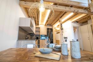 a kitchen with a wooden table with a bowl on it at Muntanyó Luxury Lodge con sauna, parking y guardaesquis en Ruda in Tredós +31 photos