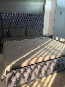 a large bed with a leather headboard in a bedroom at Pike Guest House in Dagupan