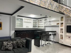 a living room with a couch and a bar at Pike Guest House in Dagupan +9 photos