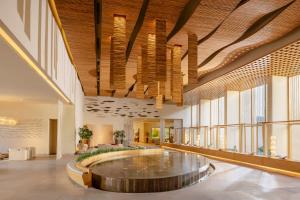 a large lobby with a large wooden ceiling at Six Senses Vana - A Wellness Retreat in Dehradun