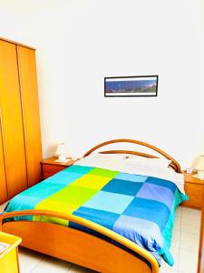 um quarto com uma cama com um cobertor colorido em Intero appartamento Bolohouse em Bolonha