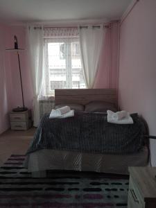 a bedroom with a bed with two towels on it at Uroczy Apartament in Kraków