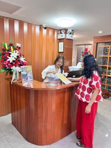 two women standing at a cash register in a salon at Aowmana Hotel in Makkasan