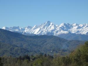 a snow covered mountain range with trees in the foreground at Chez-Judith in Boussenac