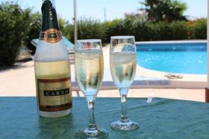 een fles champagne en twee glazen op een tafel bij Countryside private apartment with pool & sea view in Torrox