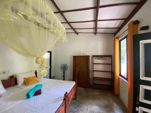 A bed or beds in a room at Nature Villa Unawatuna