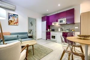 a living room with purple cabinets and a table at Apartamento Plaza España, Madrid in Madrid