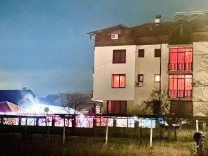 a building with a fire in front of it at Family Hotel Carpe Diem in Banya