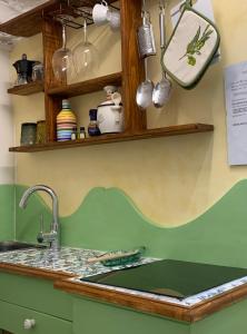a kitchen with a sink and a counter with utensils at Casa Gori in Florence