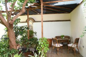 a patio with a table and chairs and a tree at Casa Gori in Florence