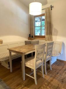 a dining room table and chairs with a table and a window at Wohnung in Kirchberg in Tirol in Kirchberg in Tirol