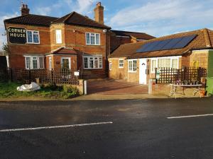 a house with solar panels on the front of it at Charming 3-Bed Apartment in Scarning Near Dereham in East Dereham