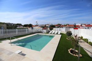 a swimming pool in the middle of a yard at Villa Marina Calan Blanes in Cala en Forcat