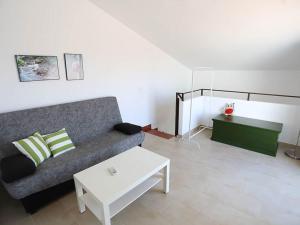 a living room with a couch and a coffee table at Villa Marina Calan Blanes in Cala en Forcat +10 photos