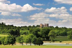 a castle on top of a hill with trees at Self contained annex in the Vale of Belvoir in Bottesford