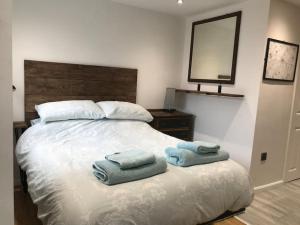a bedroom with a bed with two towels on it at Self contained annex in the Vale of Belvoir in Bottesford