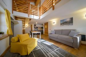 a living room with a couch and a chair at Alagna2000 in Alagna Valsesia