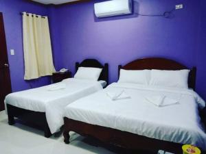 Ένα ή περισσότερα κρεβάτια σε δωμάτιο στο OYO 926 Casa Venicia Caticlan
