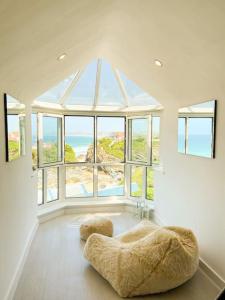 a large room with a large window and a couch at Blue Horizon Penthouse - amazing views + parking! in Newquay