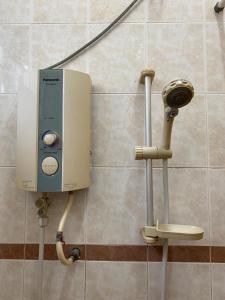 a soap dispenser on the wall of a bathroom at Spacious 4 Bedroom 3 bathroom ( Coway & Wifi) in Cukai +20 photos