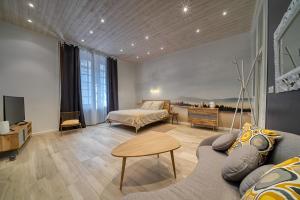 a living room with a couch and a table at Clos Grimont in Poligny