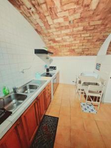 a kitchen with a sink and a table at Trastevere in Music in Rome