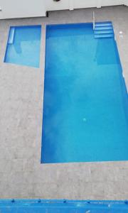 a large swimming pool with blue water at Hotel Mediterrani Express in Calella