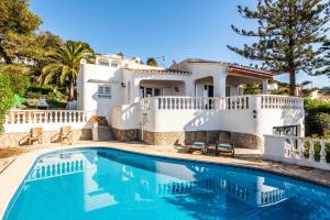 a villa with a swimming pool in front of a house at Villa Nineta in Son Bou
