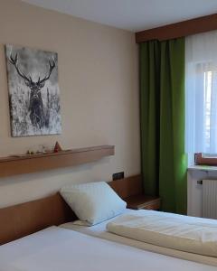 a bedroom with a bed and a green curtain at Landgasthof Heldenberg in Nenningen