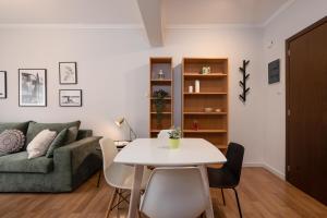 a living room with a table and a couch at Modern Apartment in Exarchia in Athens