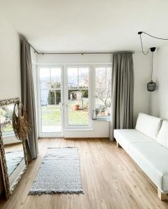 a living room with a bed and a large window at PAM Apartments in Kaprun