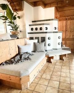a couch in a kitchen with a stove at PAM Apartments in Kaprun