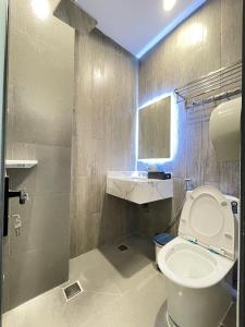 ein Badezimmer mit einem WC, einem Waschbecken und einem Spiegel in der Unterkunft TÂY NINH CITY HOTEL in Tây Ninh