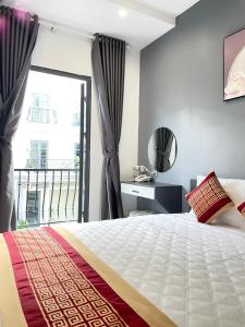 a bedroom with a bed and a window with a view at TÂY NINH CITY HOTEL in Tây Ninh