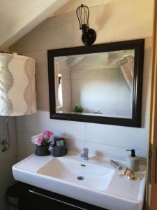 a bathroom with a sink and a mirror at Charming dalmatian apartment with panoramic view in Tkon