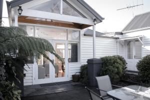 a white front door of a white house at Walton House in Huonville