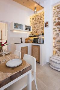 a kitchen and dining room with a table and chairs at Athena Luxury Studios in Athens