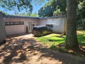 a van parked in front of a house at Imasiku House in Southbroom