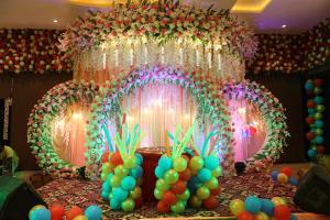 a table with a bunch of balloons and a stage at Hotel Prem Residency in Patna