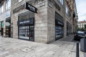 a store on the side of a building on a street at Deluxe Quentin Home next to the Fashion Street in Budapest