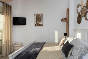 a bedroom with a bed and a tv on the wall at Athena Luxury Studios in Athens