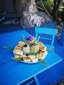 a plate of pastries sitting on a blue bench at Charming dalmatian apartment with panoramic view in Tkon