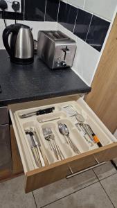 a drawer in a counter with utensils in it at Spacious 1 Br Near Lincoln City Centre Amenities in Lincoln