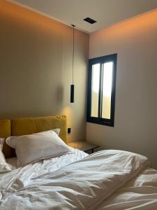 a bedroom with a bed and a window at صممت للاسترخاء in Riyadh