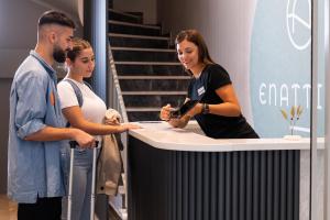 a group of people standing around a table at Enattica Suites in Athens