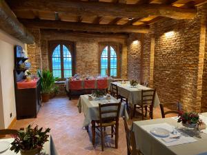 a dining room with tables and chairs in a building at Agriturismo Padernello in Borgo San Giacomo