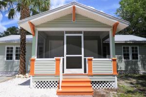 a small green house with an orange porch at Barra Villa Resort House II in Fort Myers